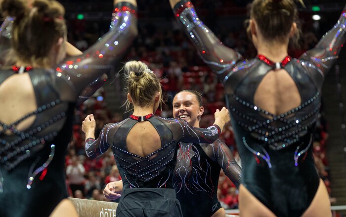 (Rick Egan | The Salt Lake Tribune)  Maile O'Keefe gets hug form a team mate after scoring a 10 on the beam, in gymnastics action between Utah  Red Rocks and Oregon State, at the Jon M. Huntsman Center, on Friday, Feb. 2, 2024.
