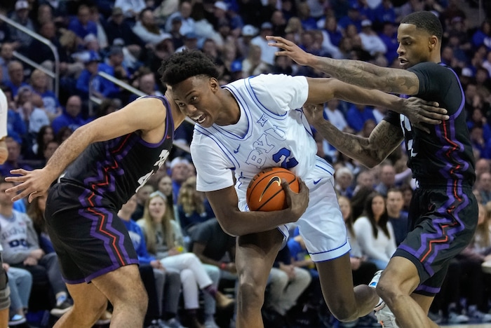 (Francisco Kjolseth  |  The Salt Lake Tribune) Brigham Young Cougars guard Jaxson Robinson (2) slips through the Horned Frogs during an NCAA college basketball game against TCU Saturday, March 2, 2024, in Provo, Utah.