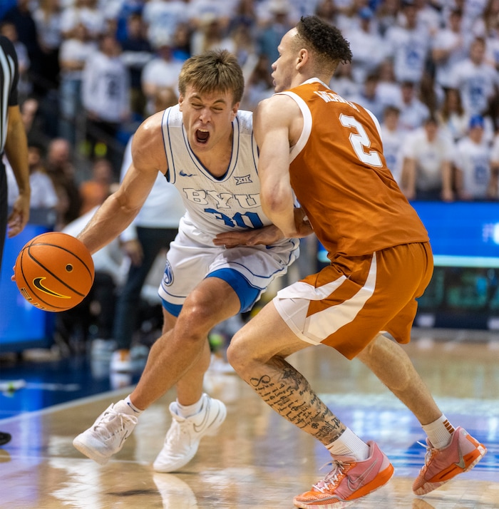 (Rick Egan | The Salt Lake Tribune) Brigham Young Cougars guard Dallin Hall (30) collides with Texas Longhorns guard Chendall Weaver (2), in basketball action at the Marriott Center, on Saturday, Jan. 27, 2024.
