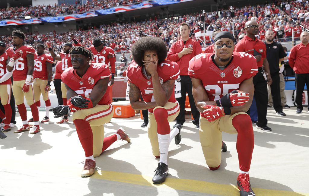 From left, The San Francisco 49's Eli Harold (58), Colin Kaepernick (7) and  Eric Reid (35) kneel during the national anthem before their a game against  the Dallas Cowboys on October 2