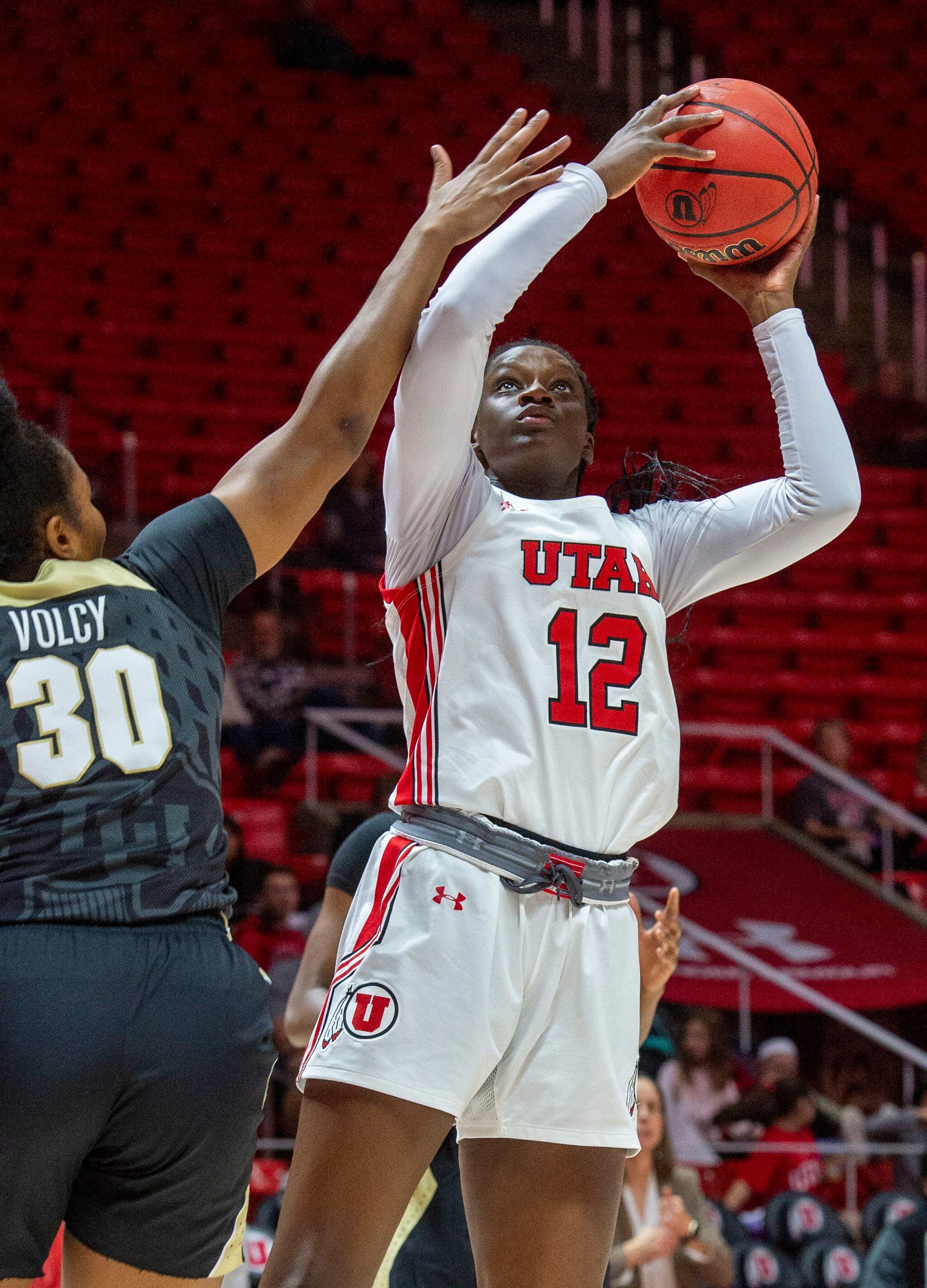 (Rick Egan | The Salt Lake Tribune) Utah forward Lola Pendande (12) shoots for the Lady Utes as Colorado Buffaloes center Kai Volcy (30) defends, in PAC-12 basketball action between the Utah Utes and the Colorado Buffaloes, at the Jon M. Huntsman Center, Sunday, Nov. 29, 2019.