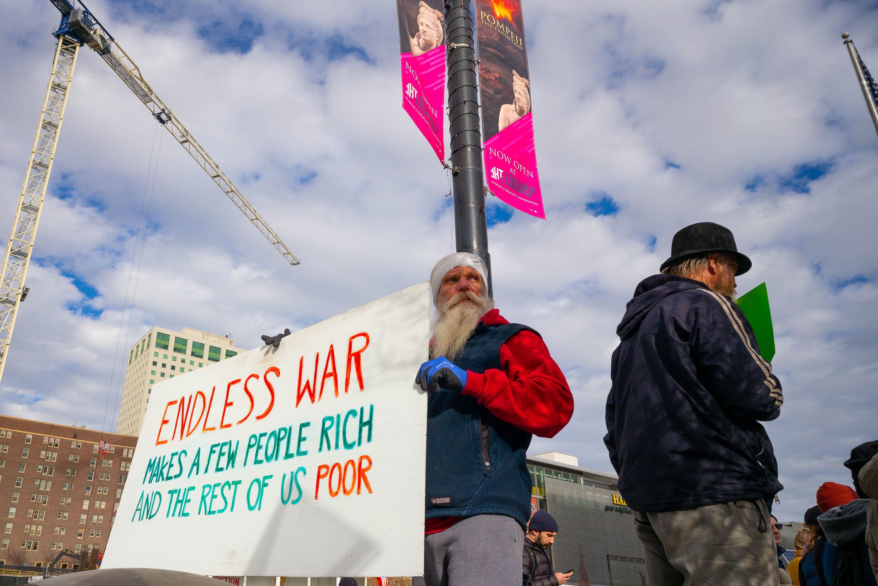 (Trent Nelson | The Salt Lake Tribune) Mahan Khalsa holds a sign as people gather in front of the Federal Building in Salt Lake City on Saturday, Jan. 4, 2020 to protest the escalation of tensions with Iran.