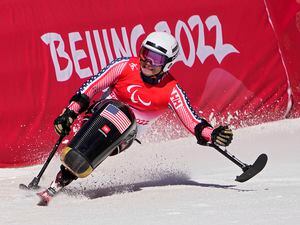 FILE - Andrew Kurka of the United States competes in the men's downhill, sitting, at the 2022 Winter Paralympics, March 5, 2022, in the Yanqing district of Beijing. U.S. Ski & Snowboard will add the Paralympic Alpine skiing and snowboard teams back under its umbrella. The two Paralympic teams have been under the management of the U.S. Olympic & Paralympic Committee since 2010. The switch allows the association to provide more support and resources to Paralympians, including coaching, sports science and psychology, along with educational opportunities. (AP Photo/Andy Wong, file)