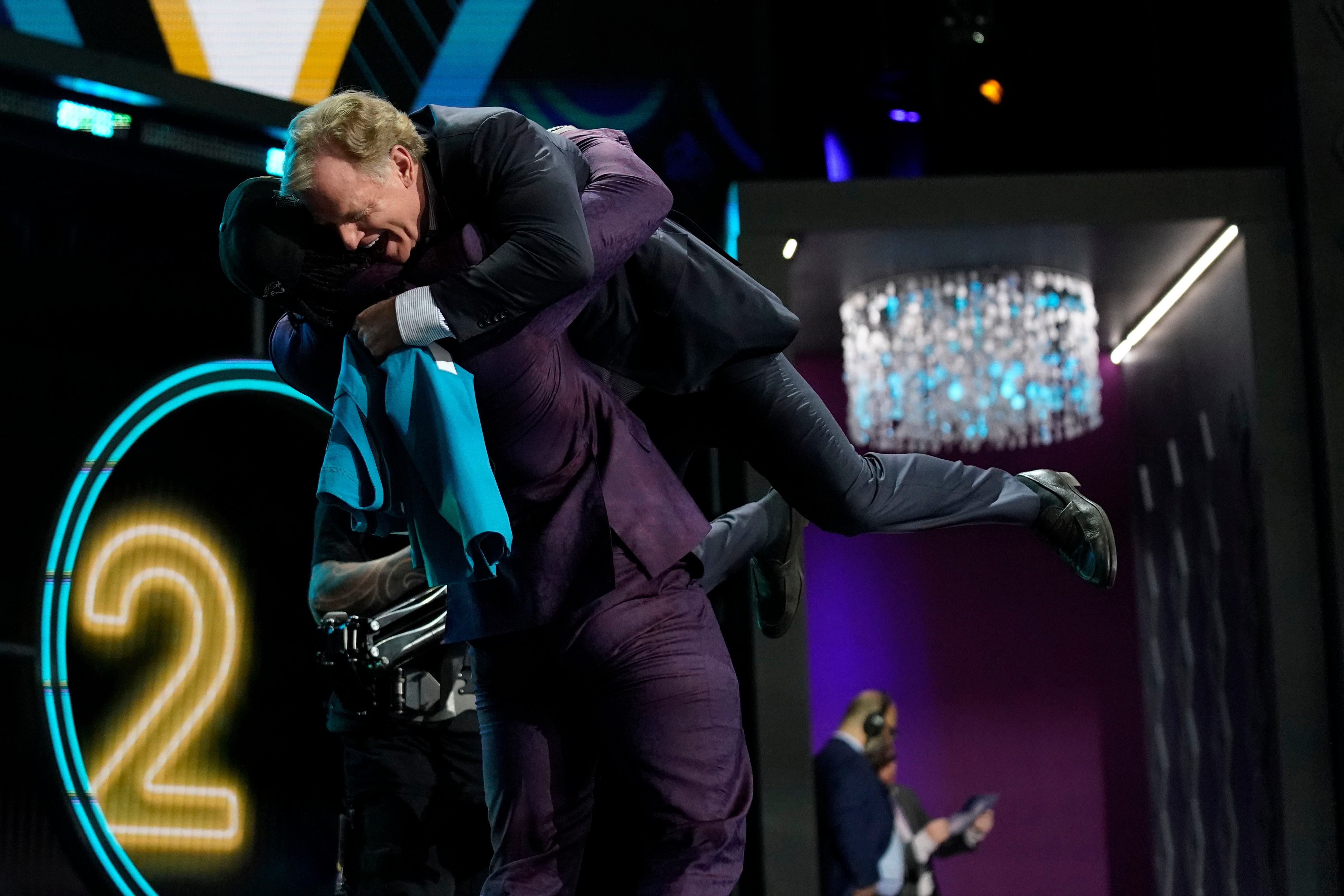 Utah Utes Devin Lloyd bear hugs Roger Goodell at NFL Draft