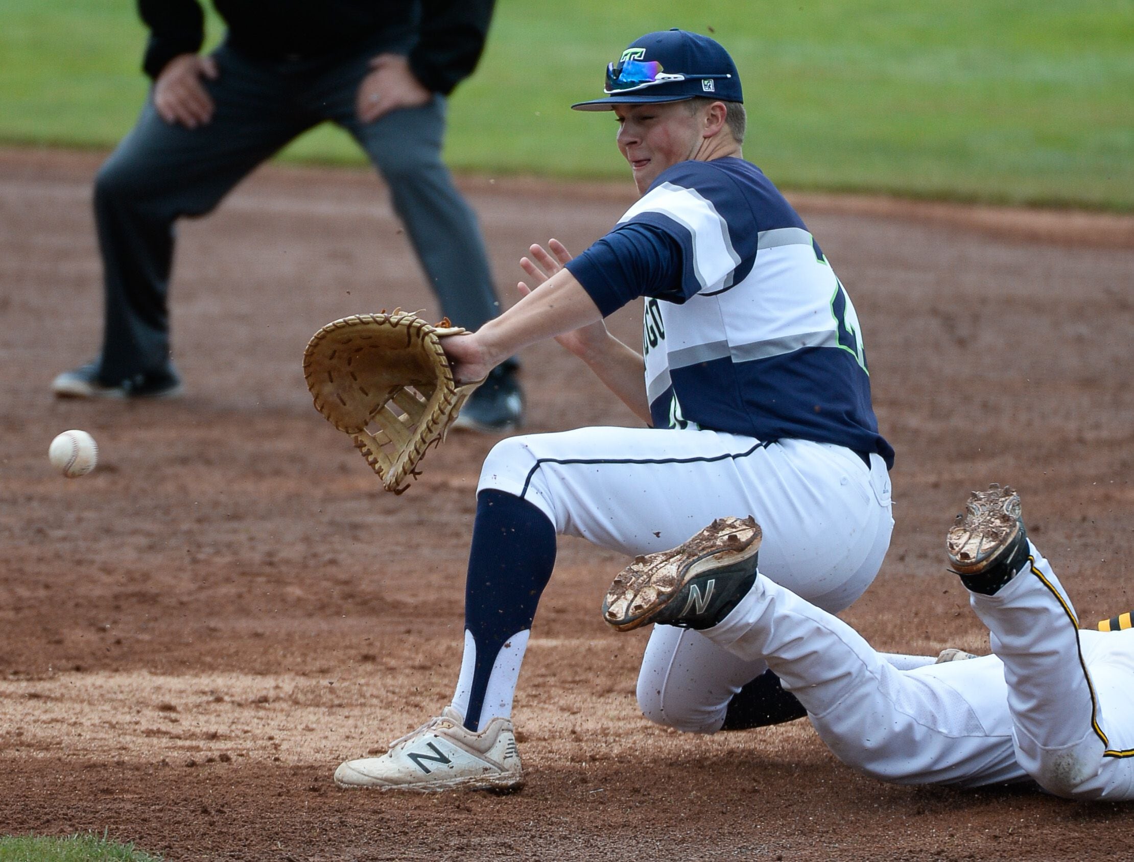 (Francisco Kjolseth | The Salt Lake Tribune) Paxton Richards of Timpanogos keeps ready as Andy Okamoto of Cottonwood beats the ball at first during the 5A baseball championship game at UCCU Stadium on the UVU campus in Orem, Friday, May 24, 2019.